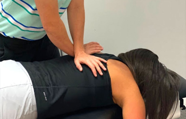 Chiropractor Southeast FL Tonya Carswell Adjusting Patient